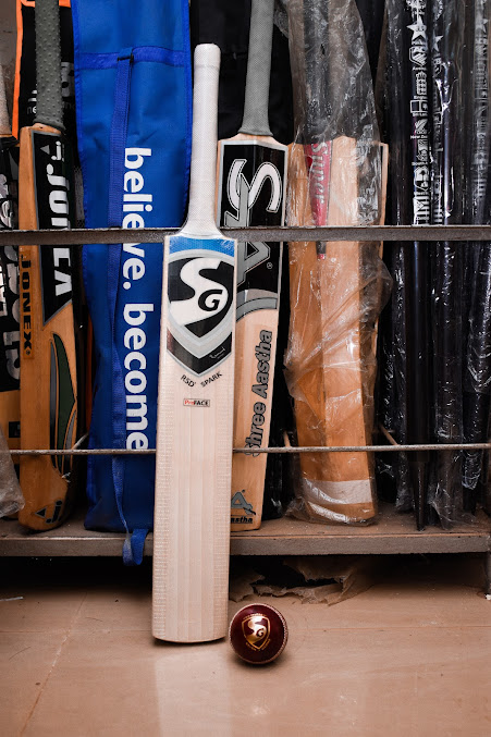 Cricket bats and rackets with cricket ball display